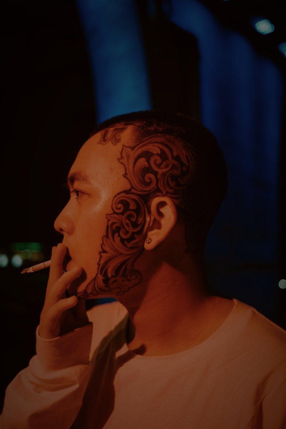 Man with face tattoos at night